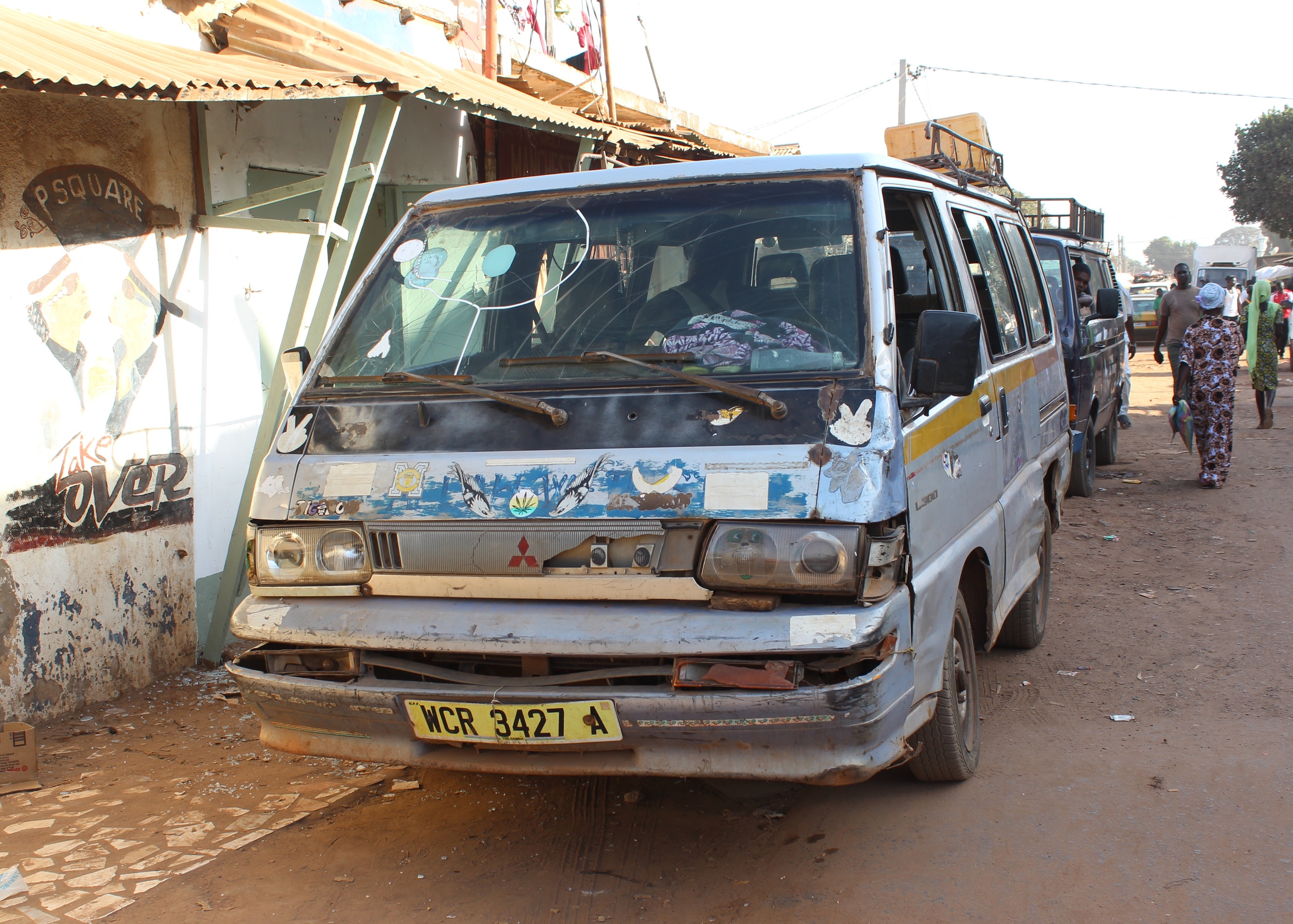 Battered but beautifully decorated passenger van.