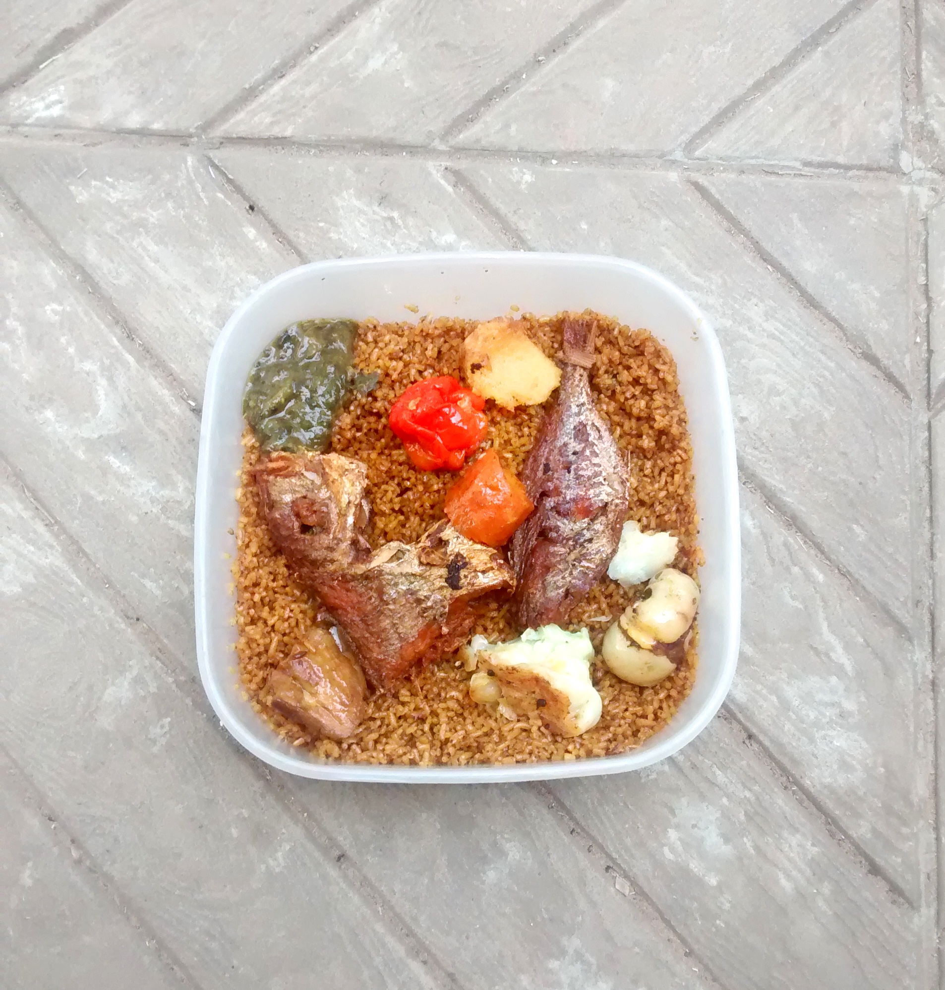 Benachin. Literally translates as 'One pot' cooking. Better than Jollof rice? Ask any Gambian (but not in the presence of a Ghanaian or Nigerian. You have been warned).